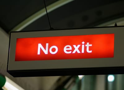 A lighted No Exit sign.