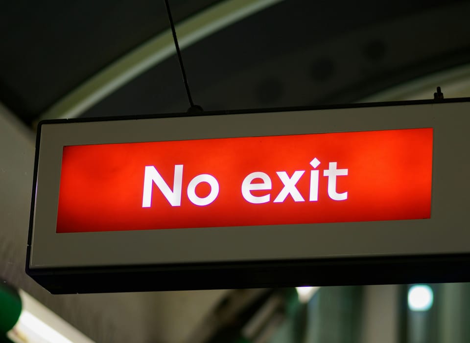 A lighted No Exit sign.